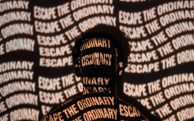 man with words on him that say escape the ordinary