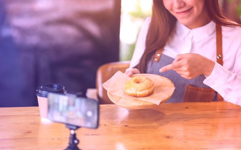 Woman shows donut on camera
